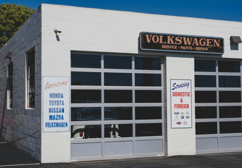 An auto repair shop with signs detailing which makes they serve, both foreign and domestic.