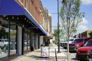 Southwest Frank Phillips Boulevard in Bartlesville, OK. A new storefront announces they are open.