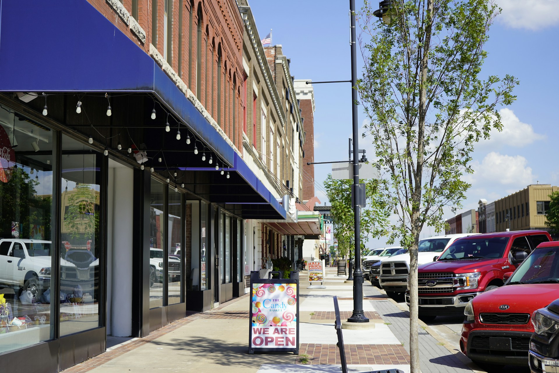 Southwest Frank Phillips Boulevard in Bartlesville, OK. A new storefront announces they are open.