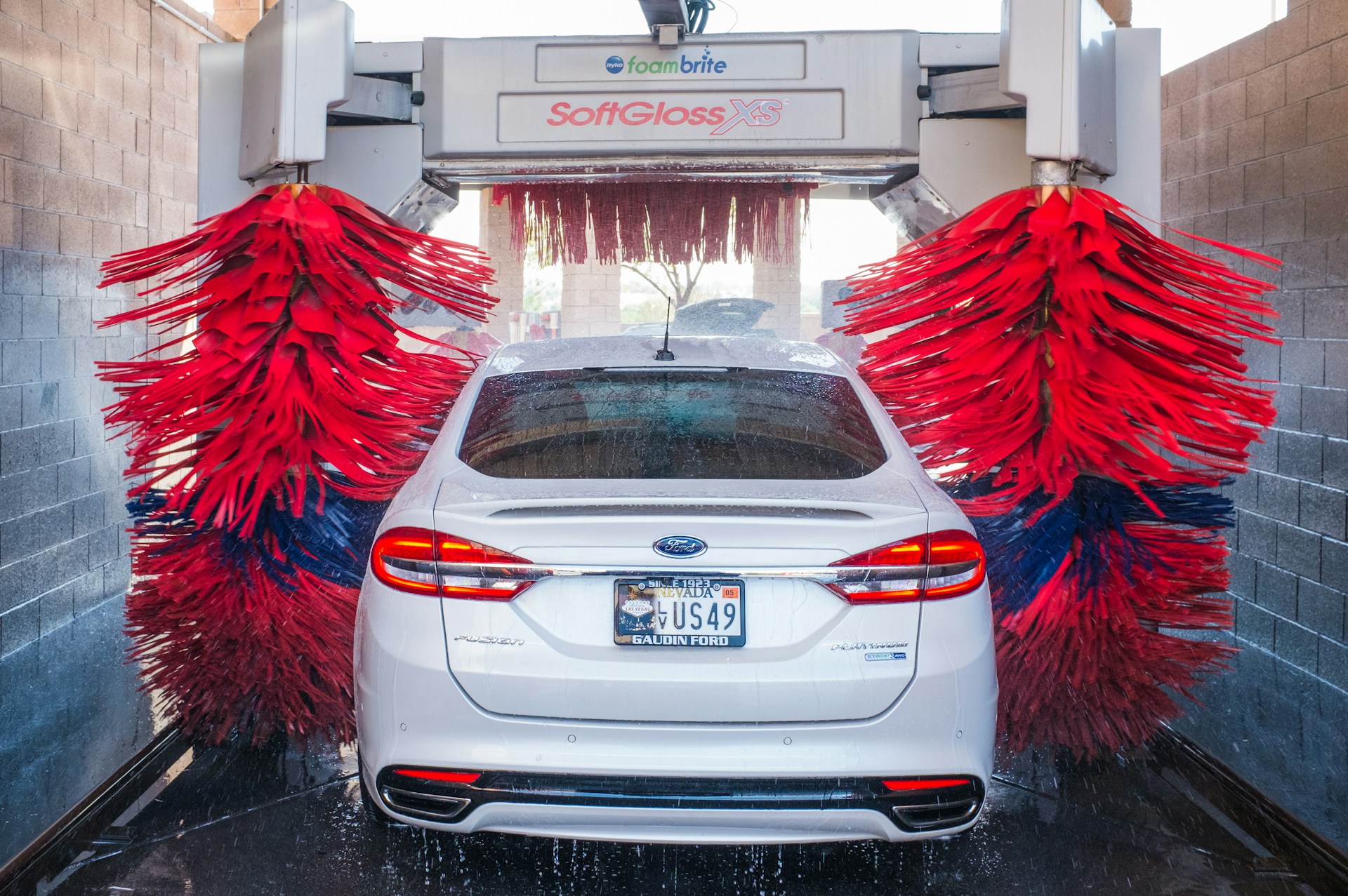 A Ford Fusion going through a car wash.